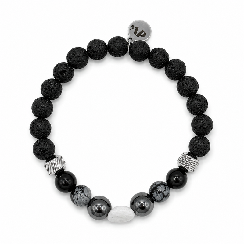Pulsera Eclipse con lava negra, obsidiana nevada, piedra blanca y detalles plateados sobre fondo blanco