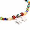Detalle del collar con cuentas de colores, motivos de ojo y estrellas blancas de efecto veteado