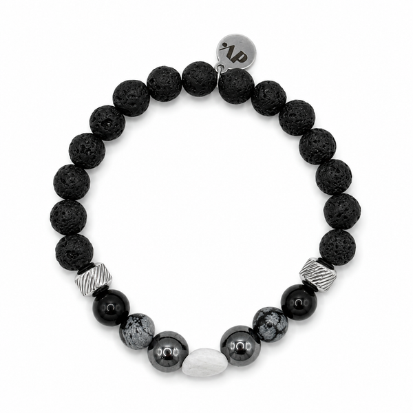 Pulsera Eclipse con lava negra, obsidiana nevada, piedra blanca y detalles plateados sobre fondo blanco